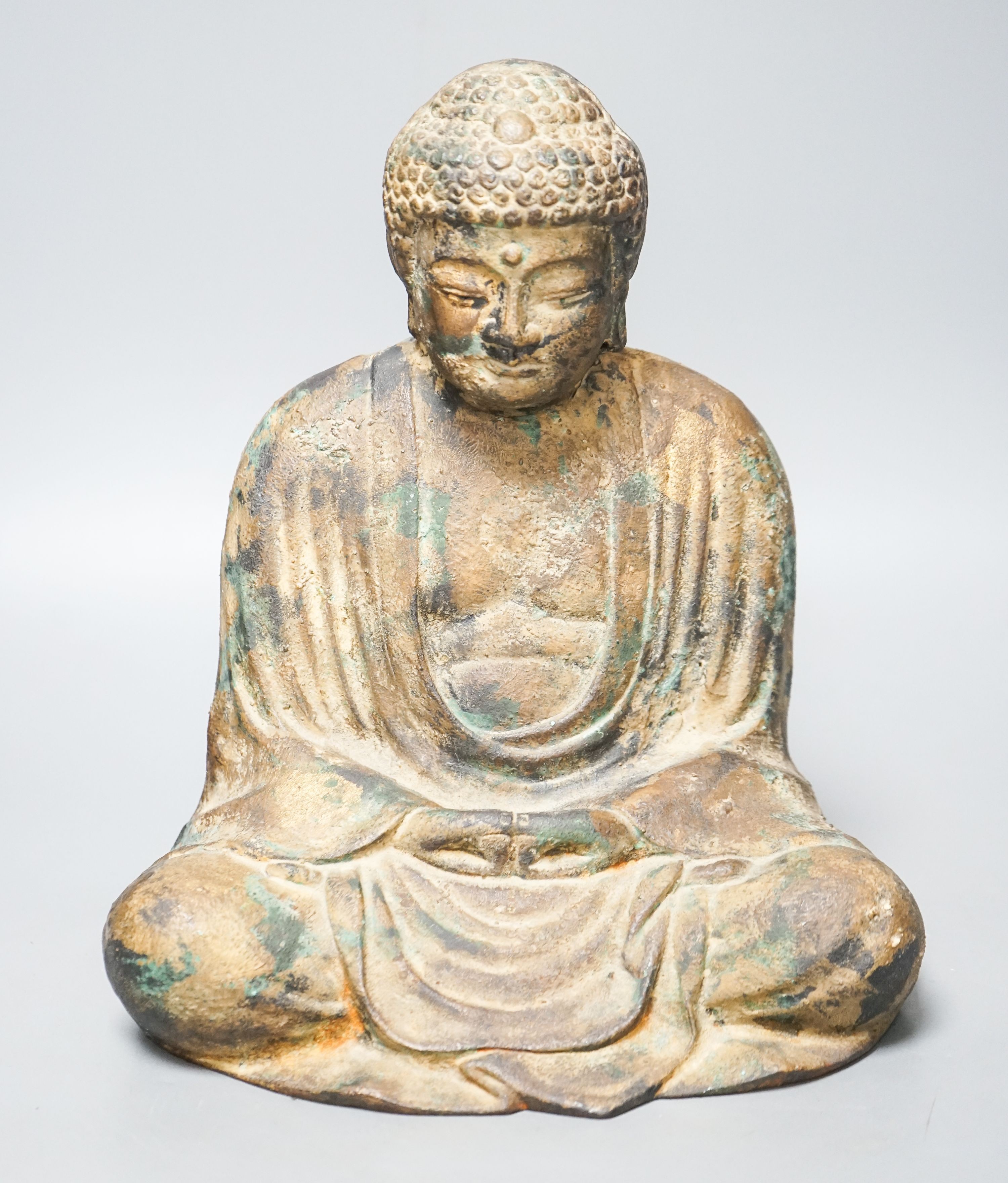 A South East Asian cast iron figure of a seated Buddha 28cm